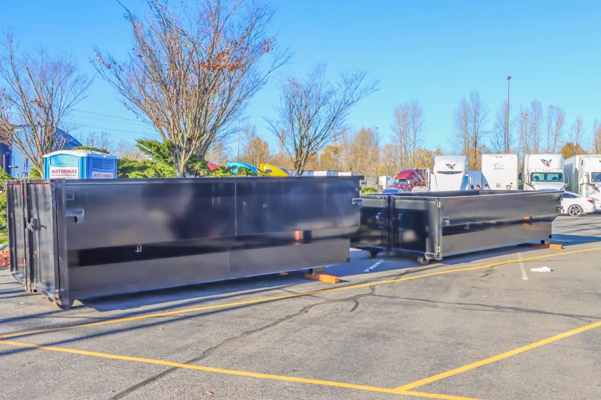 Professional dumpster rental service with roll-off container on residential driveway in Humble